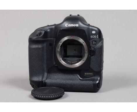 A Canon EOS-1 DS DSLR Camera Body, serial no 103281, body G, light wear, with body cap, strap, manual, battery and charger