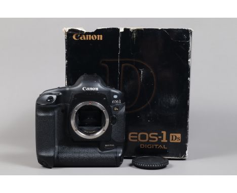 A Canon EOS-1 DS DSLR Camera Body, serial no 108598, body G, some wear to edges, with body cap, strap, battery, charger, manu