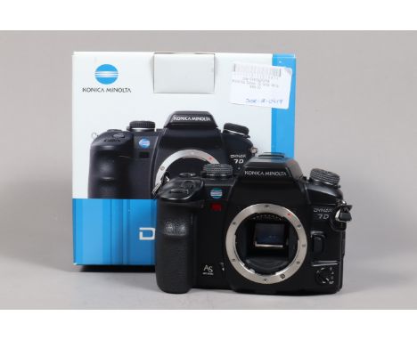 A Konica Minolta 7D DSLR Camera Body, powers up, shutter working, body G-VG, with battery &amp; charger, in maker's box