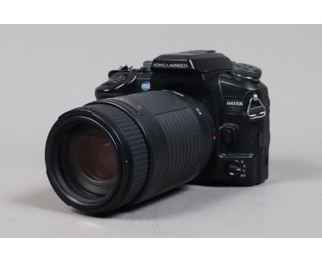 A Konica Minolta 7D DSLR Camera,  powers up, shutter working, body G, with SigmaDL Zoom 75-300mm f/4-5.6 lens, auto focus fun