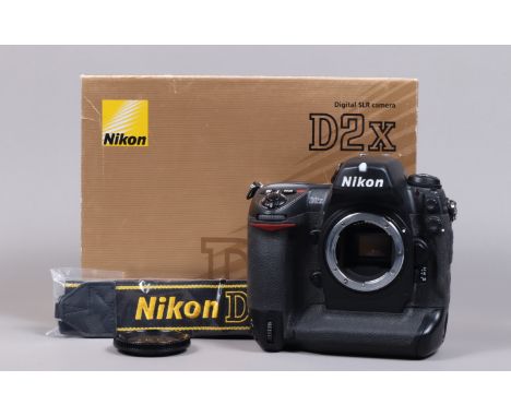 A Nikon D2x DSLR Camera Body, serial no 5067870, body G, light wear, with body cap, display screen cover, strap, manual, boxe