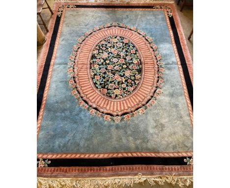 An Indian floral medallion carpet, with a sky blue field within a pink and blue border, 375 x282cm