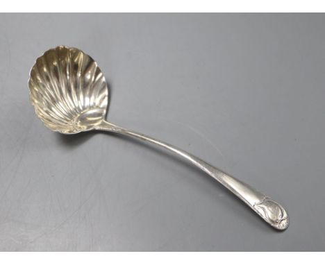 A George III base marked silver sauce ladle with scallop shell bowl, marks rubbed