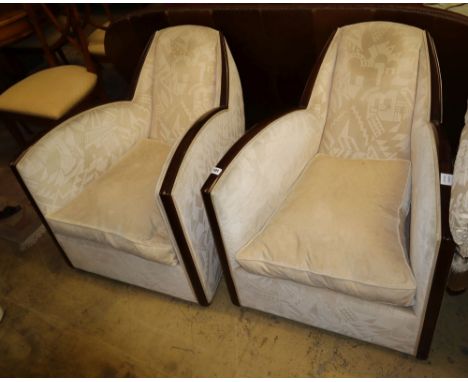 A pair of 1930's French Art Deco walnut framed armchairs, with deco design cream upholstery, W.69cm, D.85cm, H.63cm