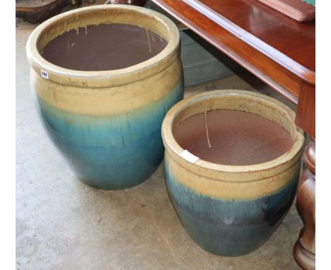 A graduated pair of glazed ceramic garden planters, largest W.48cm, H.51cm
