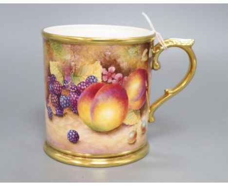 A Royal Worcester mug, designed with fruit and signed C.Hughes, height 12cm