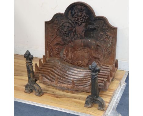 A cast iron fire grate, dogs and lion and thistle fireback, W.64cm, H.62cm