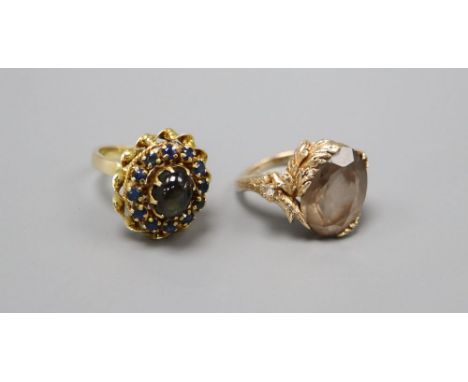 An 18k gold cabochon and sapphire cluster ring, size L, gross 5.9 grams and a 9ct. gold gem set dress ring, size M, gross 6.8