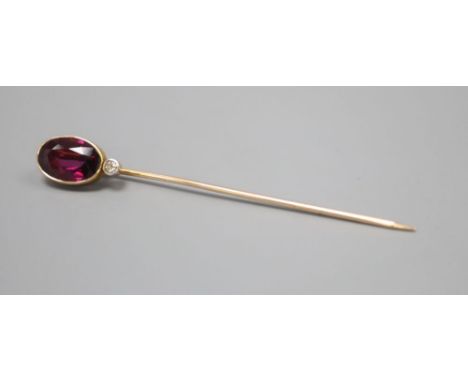 An Edwardian yellow metal, garnet and diamond set stick pin, 64mm, gross 2.2 grams.CONDITION: No visible damage to either of 