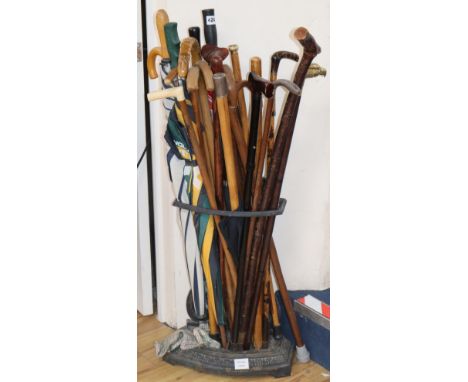 A Victorian black painted cast iron stick and umbrella stand, a Victorian gold and citrine mounted malacca cane and a quantit