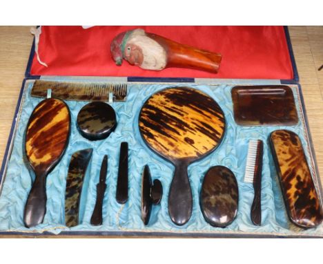A cased tortoiseshell dressing table set and a gnome nut cracker