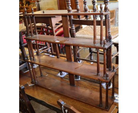 A Victorian mahogany four tier wall bracket with acorn finials, W.84cm, D.16cm, H.74cm