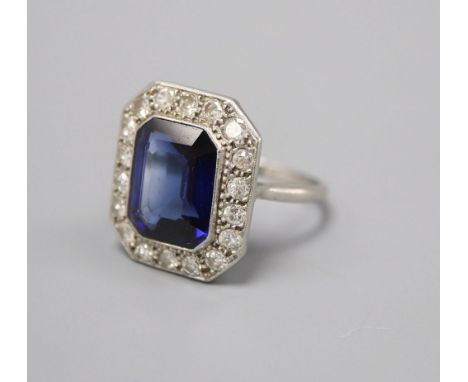 A platinum synthetic sapphire and diamond octagonal cluster ring, size O