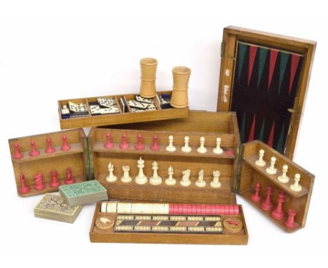 Victorian games compendium, the oak case enclosing an ivory and stained chess set, draughts pieces, games counters, cribbage 