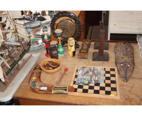A quantity of wooden items to include a dinner gong; candle sticks; chess board and pieces; boomerang; face mask etc