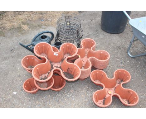 A quantity of plastic planters; planter stands and watering cans