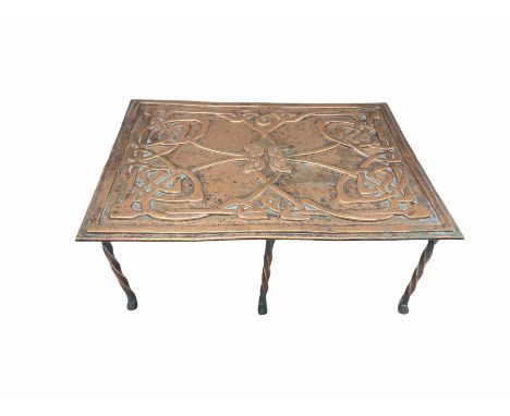 Scottish Arts and Crafts copper trivet of rectangular form with embossed Celtic design on twisted copper supports, L31cm 