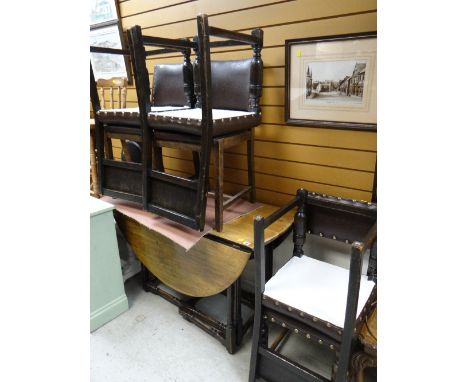 A good oak circular gate legged dining table together with six matching brown leatherette & studded seat & back dining chairs