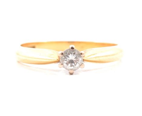 A diamond solitaire ring, the brilliant cut stone claw set in an 18 carat yellow and white gold mount ring size N, London 199