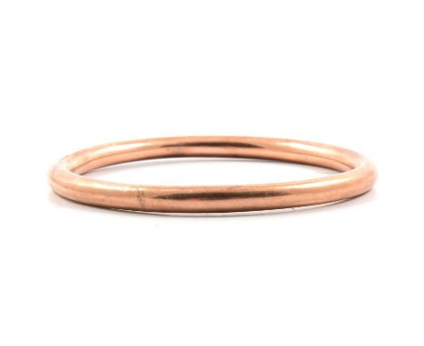 A 9 carat rose gold slave bangle, 6.3mm gauge plain polished hollow construction, 7cm internal diameter, hallmarked Birmingha