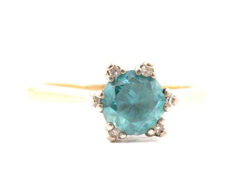 A heat treated blue zircon ring, the 6.8mm brilliant cut zircon set with six diamond topped raised claws in a yellow and whit
