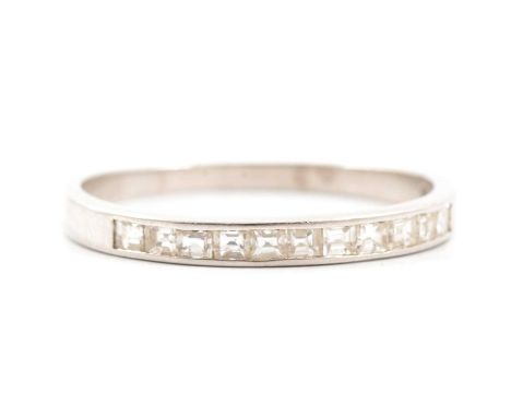 A diamond half eternity ring, eleven square cut diamonds channel set in a platinum mount, 2.6mm wide at head, ring size T, ha