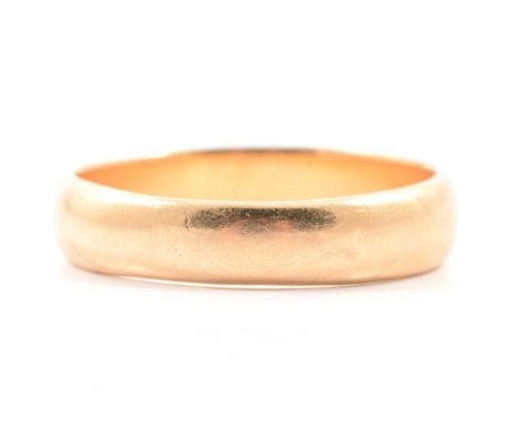 An 18 carat yellow gold wedding band, 4.8mm wide plain polished D shape, ring size V, hallmarked Birmingham 1916, 5.6g.