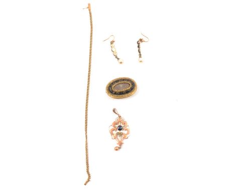 An In Memoriam brooch, hair compartment to centre with black enamel border, gold-plated closed back mount, 32x25mm; an Edward