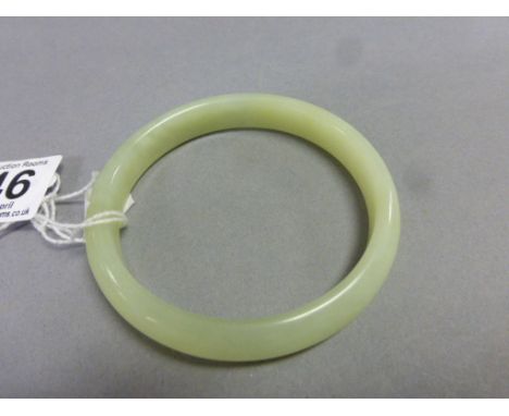 A Chinese pale green hard stone bangle 