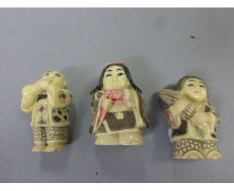 Three netsuke style carvings to include Lady with Parasol