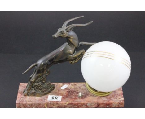 An Art Deco lamp with a spelter figure of a leaping antelope 