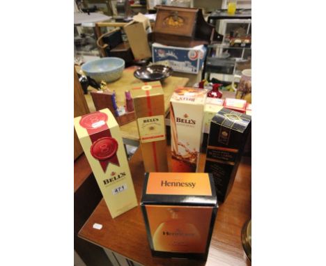 Three Boxed Bottles of Bells Whiskey, Boxed Bottle of Johnnie Walker Black Label Whiskey and Boxed Bottle of Hennessy Cognac