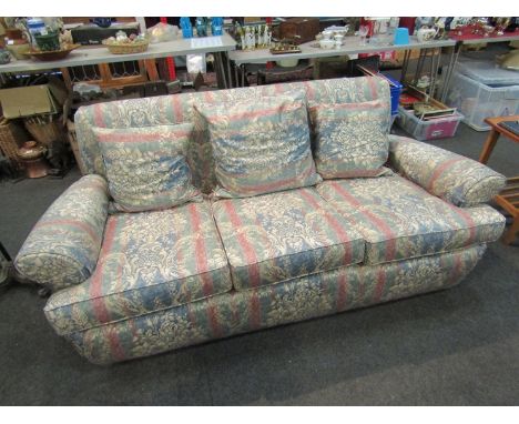 An early 20th Century sofa with feather filled cushions, floral silk upholstery and a similar 20th Century three seater sofa