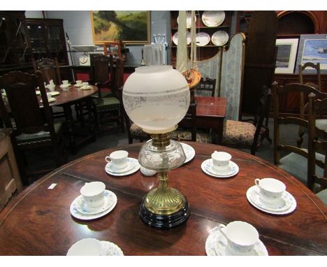 A brass based oil lamp with etched shade, 58cm tall