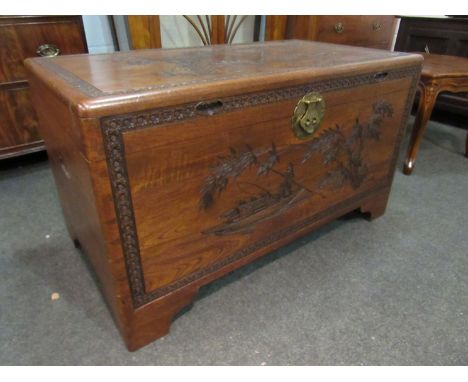 A mid 20th Century Southeast Asia camphor wood trunk with carved decoration and sliding tray (with lock), 101cm x 55cm x 56cm
