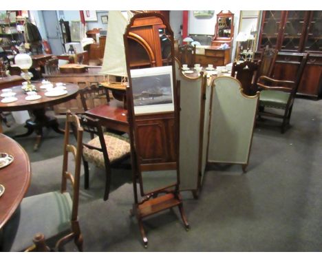 An Edwardian mahogany cheval mirror with base shelf over outswept legs on brass castors, 164cm tall