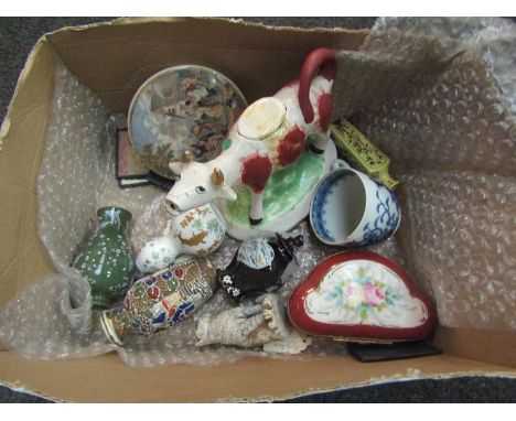 A box containing assorted items including a 19th Century cow creamer, a porcelain patch box, miniature vases and paintings