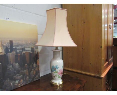 A decorative table lamp with shade