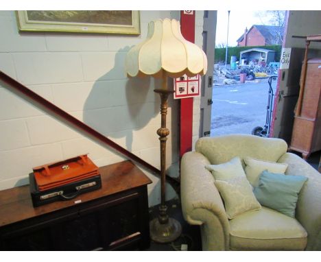 A gilded standard lamp with shade