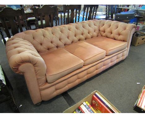 An Edwardian button back Chesterfield three seater sofa on bun feet and castors, 198cm long x 68cm tall x 86cm deep