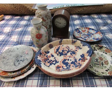 A box containing mantel clock, vases, plates and place mats