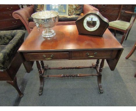 A George III style flame mahogany sofa table the reeded edge top and rising leaves over two freize drawers on twin turned end