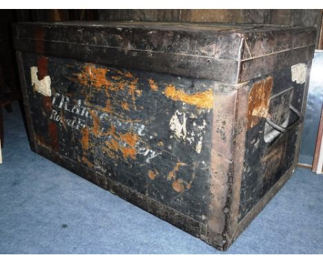 A ZINC LINED TRAVELLING TRUNK, metal bound with iron carrying handles labelled 'Army & Navy C.S.L makers London, Bombay, Calc