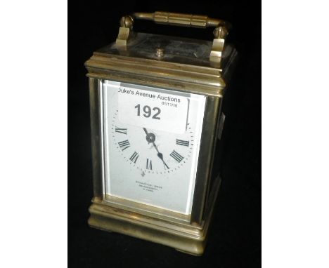A BRASS-CASED CARRIAGE CLOCK, the white enamel dial signed 'Primavesi, Bros., Bournemouth & Paris'
