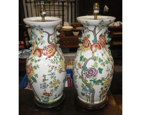 A PAIR OF CERAMIC TABLE LAMPS  in the form of Oriental vases decorated with peonies 20" high (overall, plus bayonet fitting)