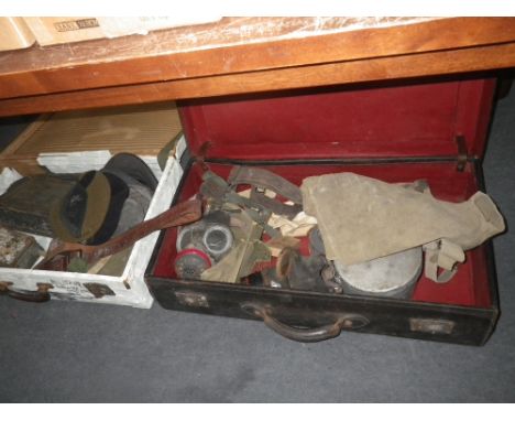 TWO VINTAGE CASES CONTAINING OLD ARMY ITEMS INCLUDING: Gas masks, belts, caps and tins
