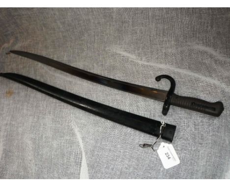 A SWORD TYPE BAYONET IN SCABBARD, engraved to the back of the blade 'St Etienne, 1873'