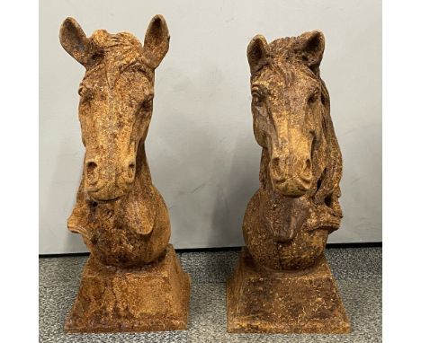 A pair of cast iron horse head garden ornaments, H. 45cm.