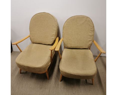 A pair of Ercol blonde elm armchairs, H. 77cm D. 90cm.