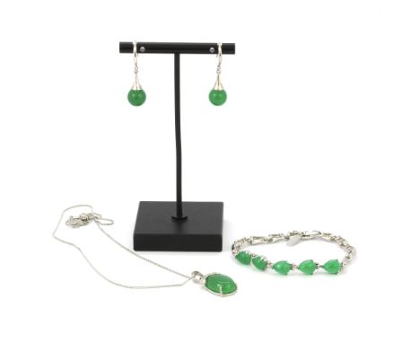 A white metal and jade set suite comprising bracelet, pendant and chain with earrings.